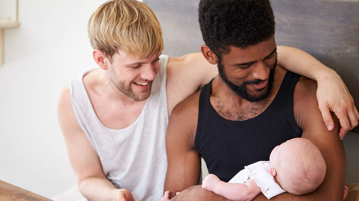 two men with a baby
