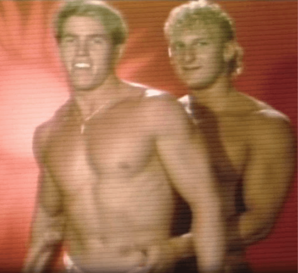 Two shirtless performers embrace during a segment from The Robin Byrd Show.