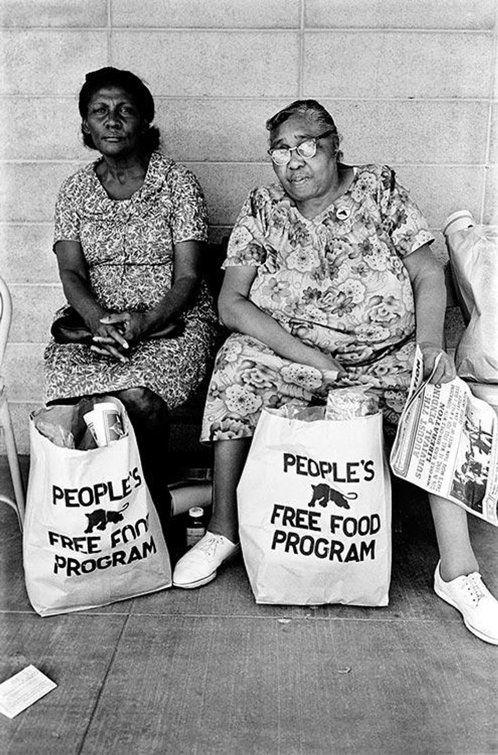 Two women with bags of food at the People's Free Food Program