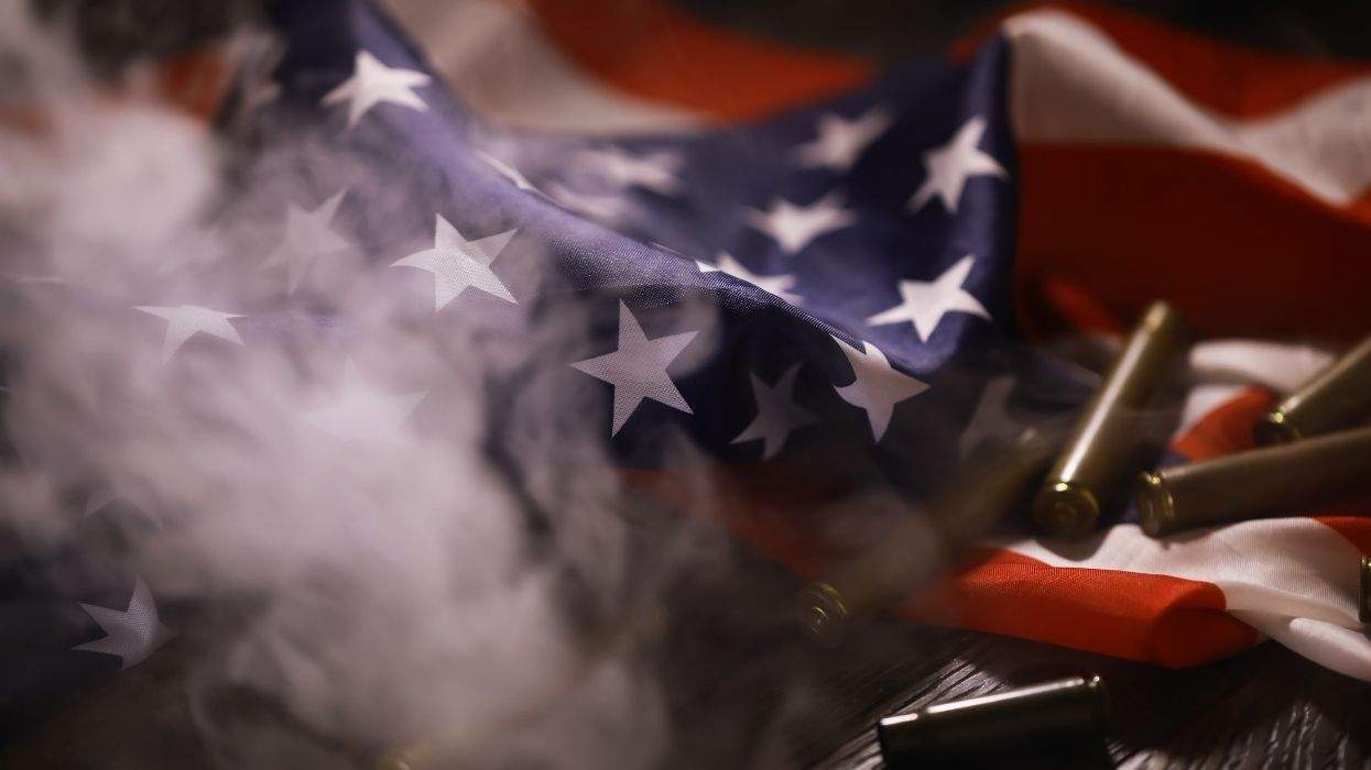 u.s. flag with smoke and bullet casings