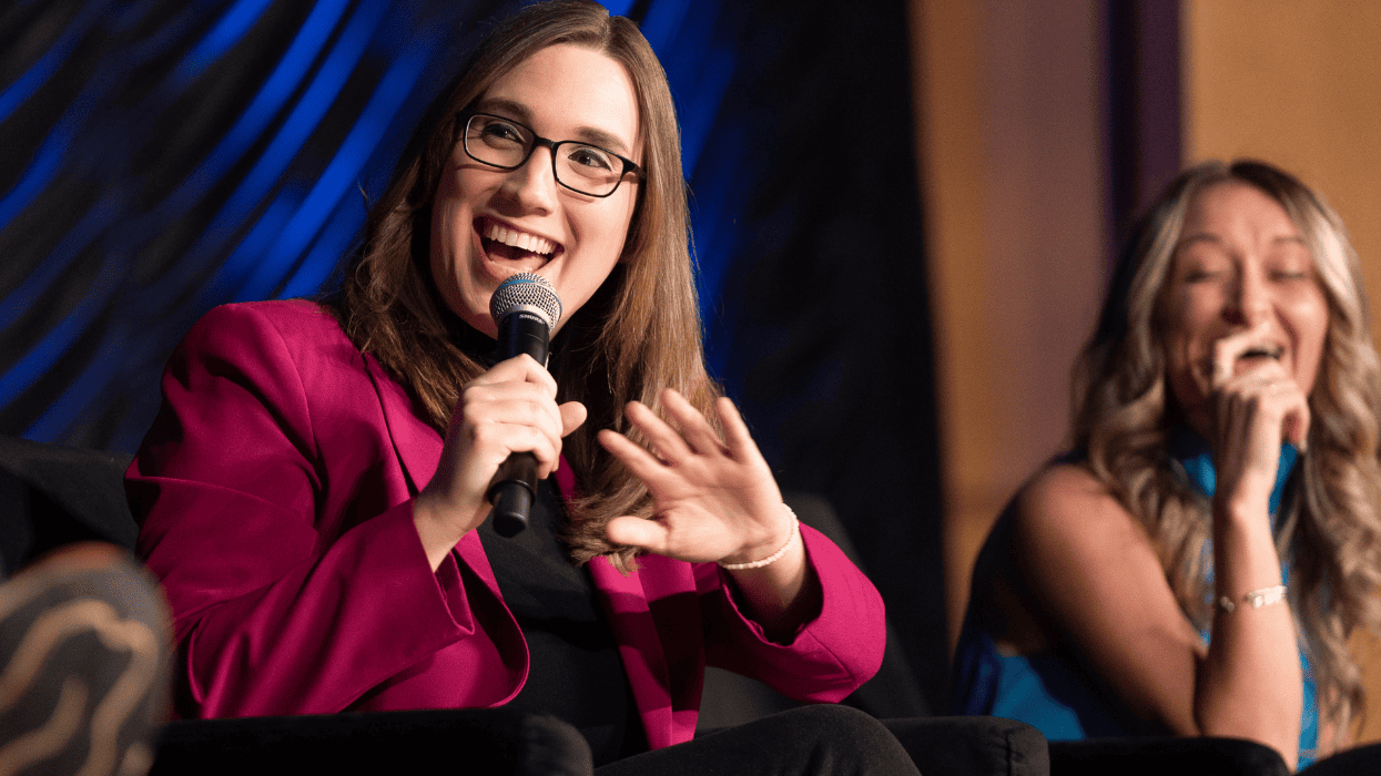 U.S. Rep. Sarah McBride speaking and Anderson Clayton laughing