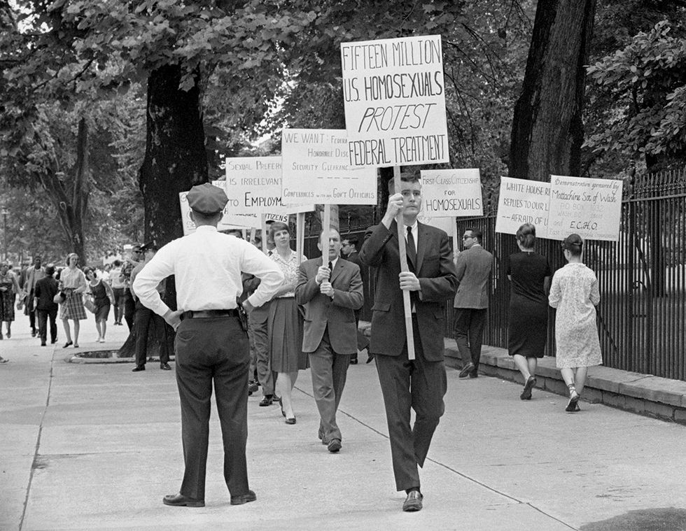 \u200bAmerican gay rights activists Jack Nichols followed by Frank Kameny and Lilli Vincenz protesting with others outside the White House on Armed Forces Day Washington DC May 1965