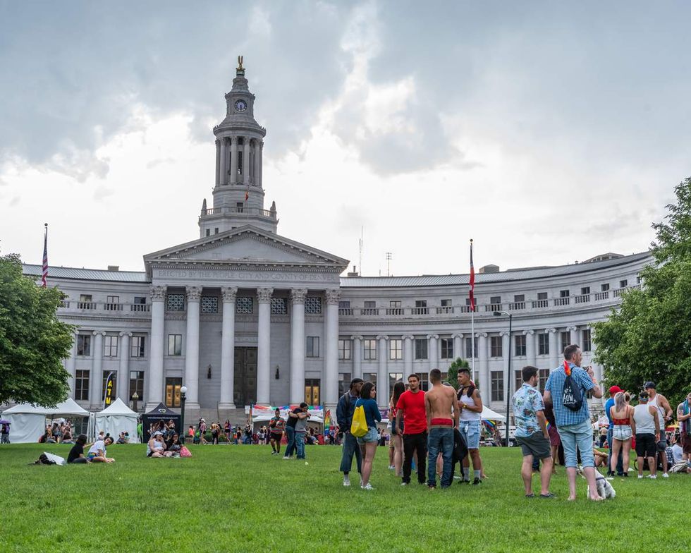 \u200bDenver Pride hang out on the lawn outside of the City Council Building