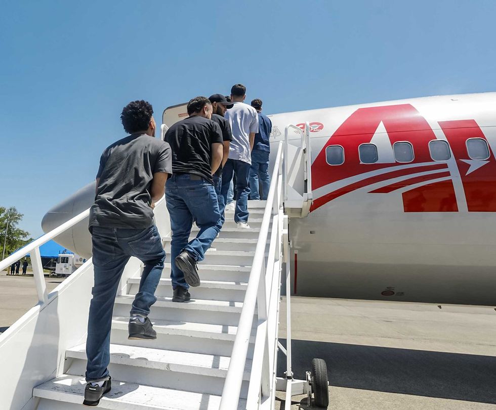 Venezuelan migrants boarding an airplane