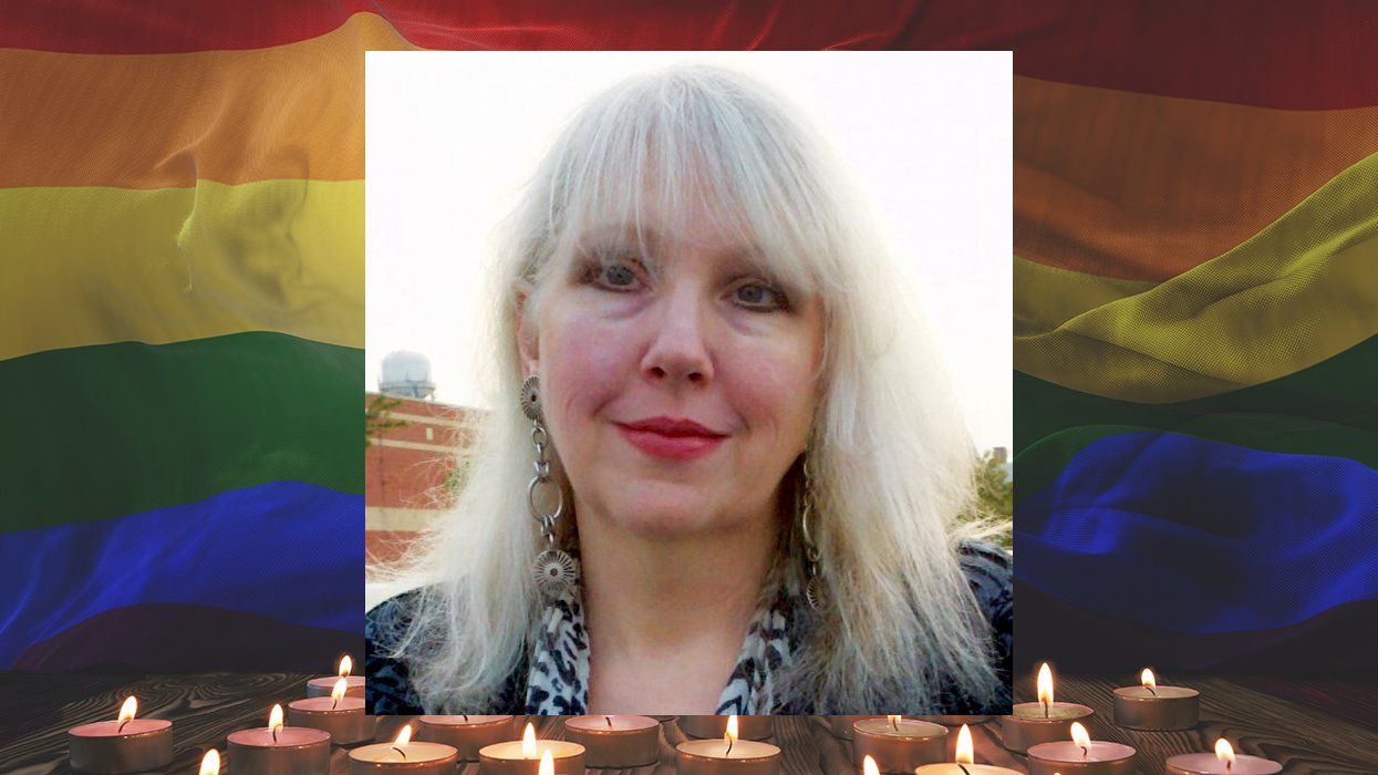 Victoria A. Brownworth, author of Ordinary Mayhem, over rainbow flag with tealight candles