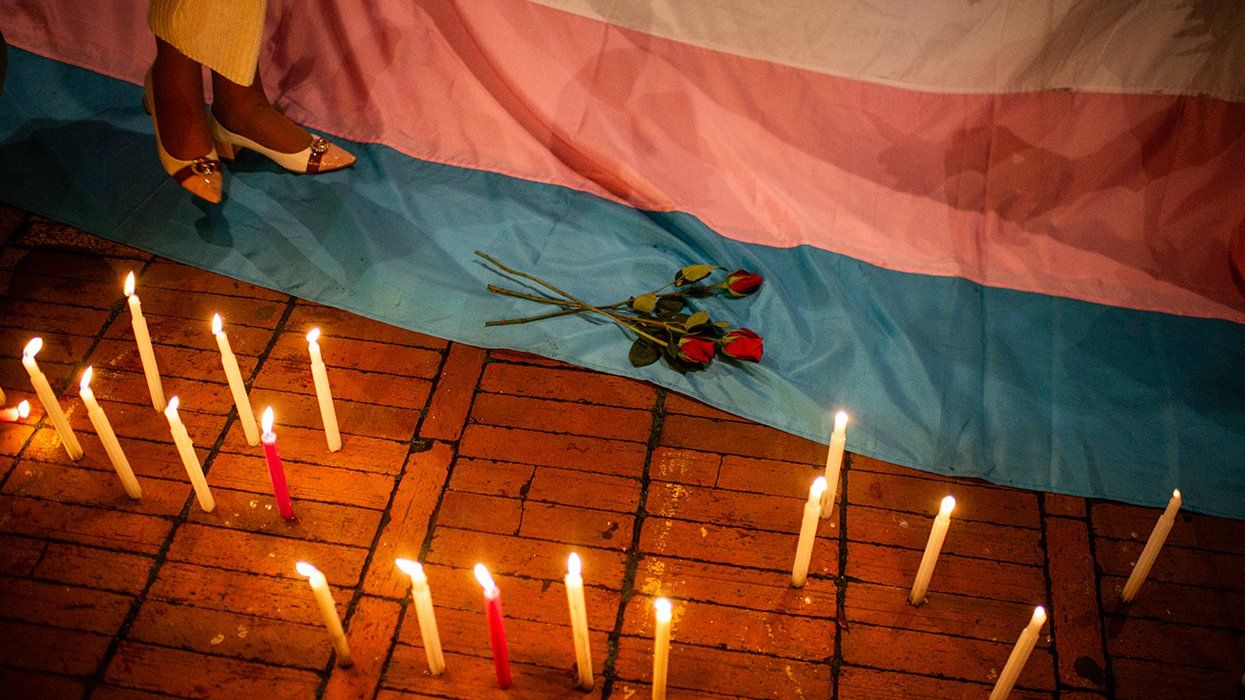 Vigil Against The Trans Femicide Of Sara Millerey roses candles and transgender pride flag