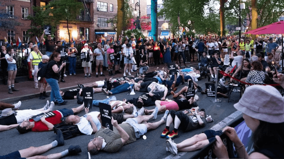 Vigil participants stage a die-in on New York City's Christopher Street, just outside the Stonewall Inn.
