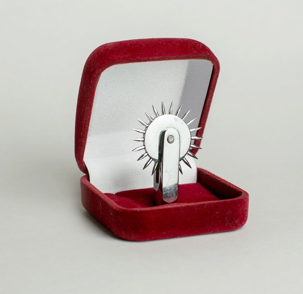 Wartenberg wheel head in a red velvet ring box