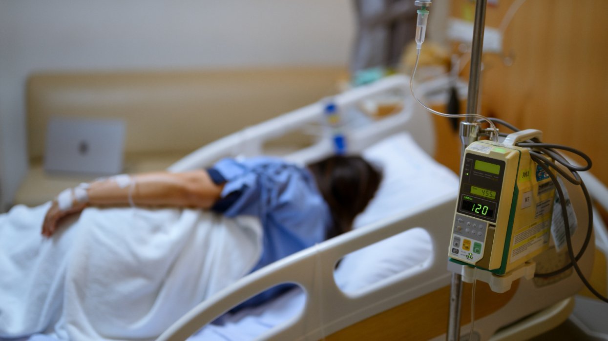 Woman in hospital bed with vital signs