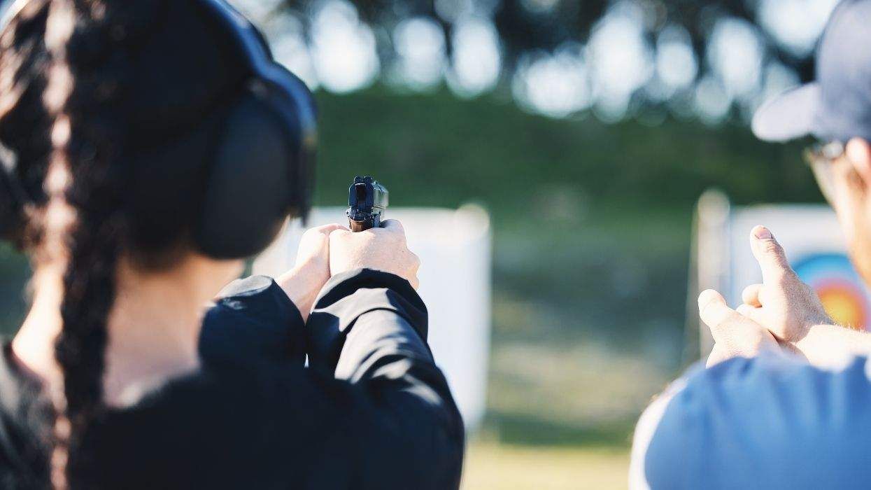woman learning to shoot a gun