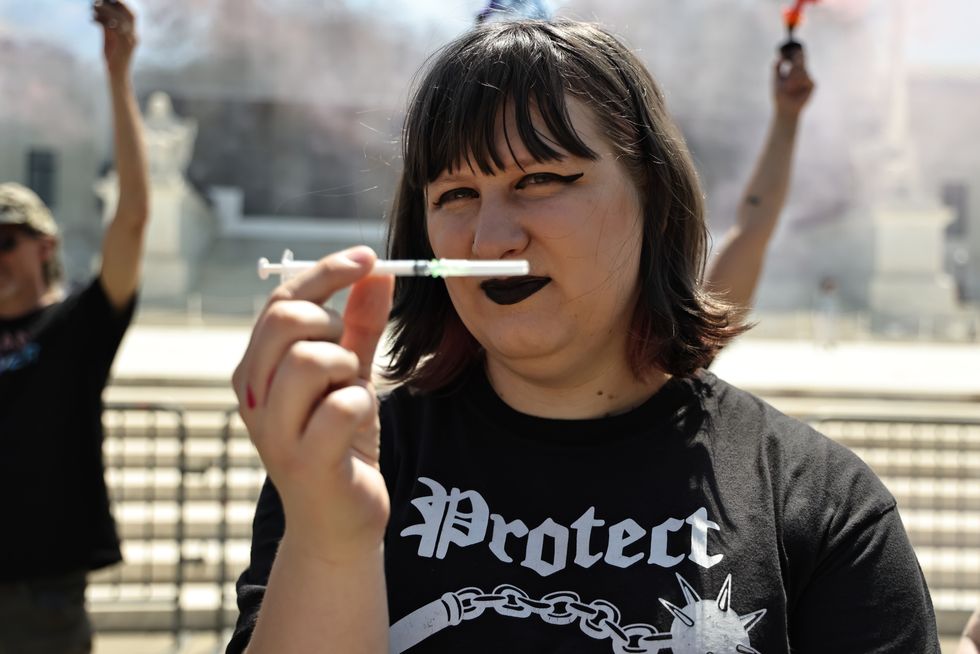 Woman shows off HRT injection outside SCOTUS\u200b
