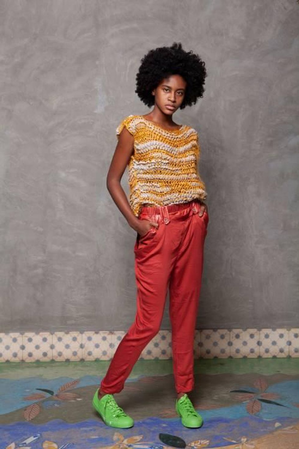 Woman wearing knit top and red pants, the top from WeDu by Coreon Du is made from fabric remnants