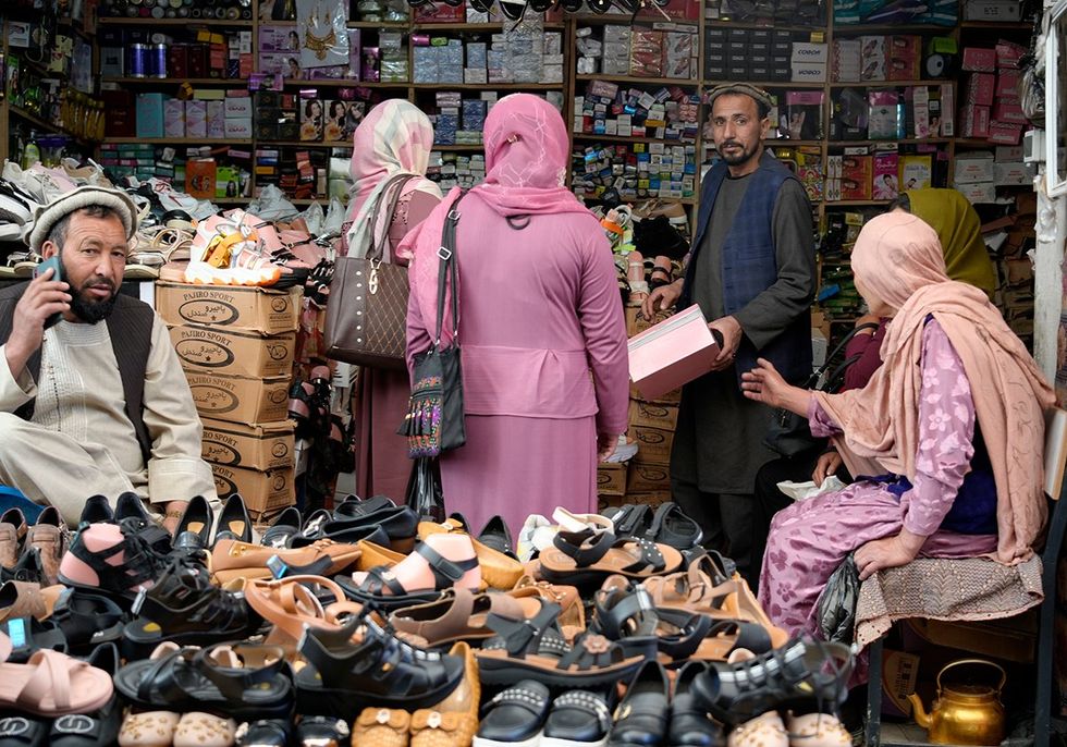 Women shopping for shoes in Bamiyan Bazaar, central Afghanistan