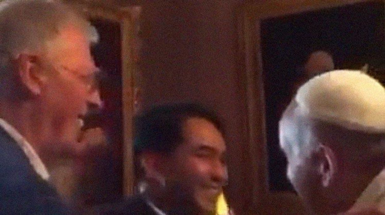 Yayo Grassi, left, watches as his partner Iwan hugs Pope Francis