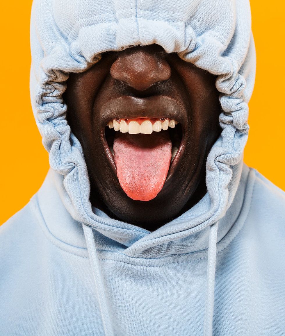 young Black man tongue out hoodie over eyes