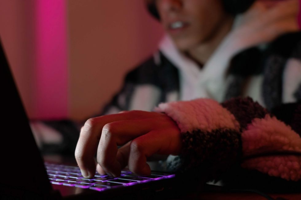 Young men playing games and streaming on his computer.