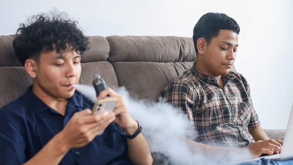 Young people vaping on a couch