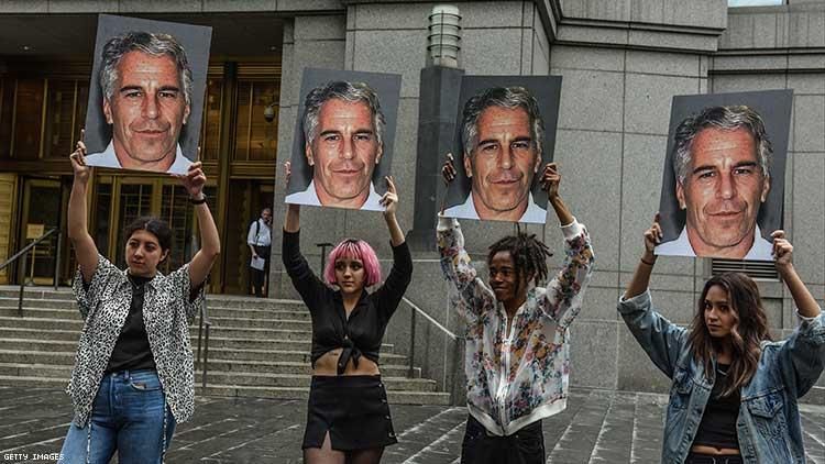 A protest group called "Hot Mess" hold up signs of Jeffrey Epstein in front of the Federal courthouse on July 8 2019.