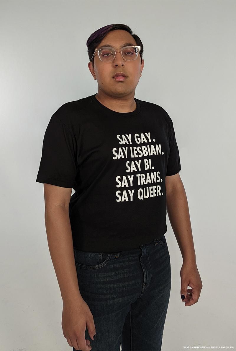 Sameer Jha wears a black t shirt with white text that reads, "Say Gay. Say Lesbian. Say Bi. Say Trans. Say Queer."