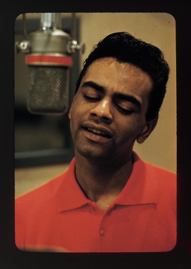 Younger Johnny Mathis singing in a studio