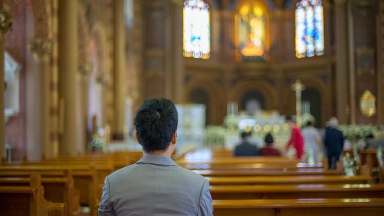 Person sitting on church pew