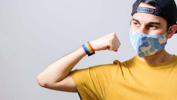 Man with mask and rainbow wristband