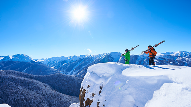 two skiers on a mountain top