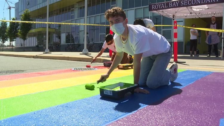 a student painting a crosswalk