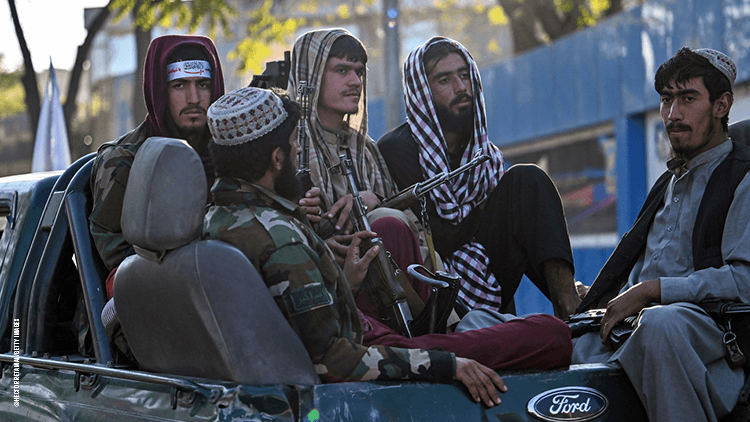 Taliban soldiers in the back of a truck