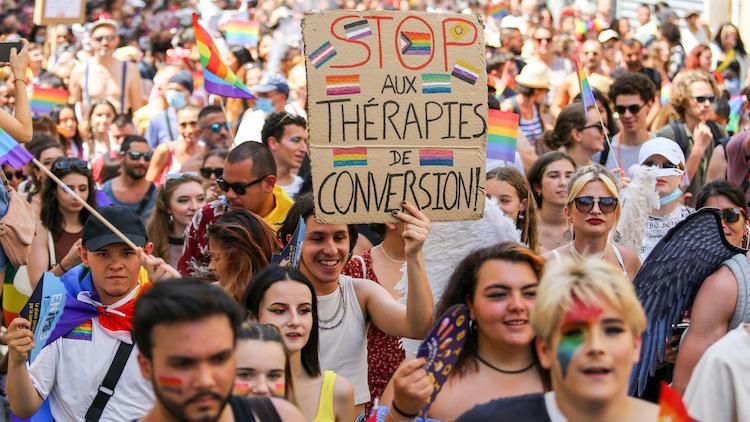 Pride march in France with a sign against conversion therapy