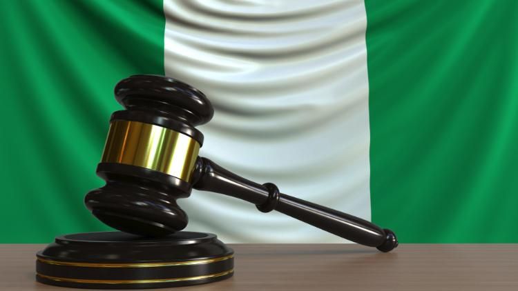 gavel in front of Nigerian flag