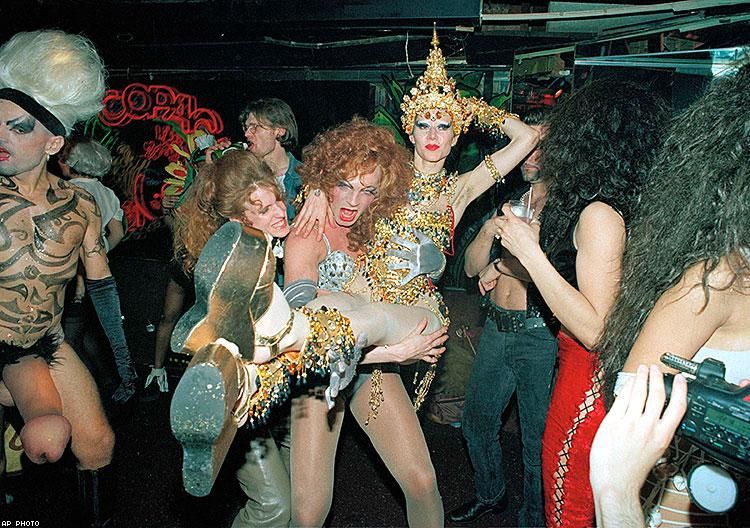 Above: Globetrotting party hostess Susanne Bartsch is carried across the dance floor during one of her all-out happenings at the Copacabana night club in New York, June 4, 1992.