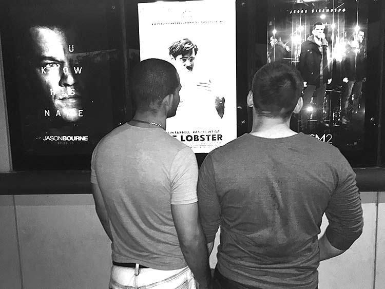 2. Sitting beside each other in a movie theater.