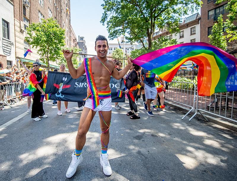 A person walks the New York City Pride Parade on June 26, 2022 wearing rainbow colors