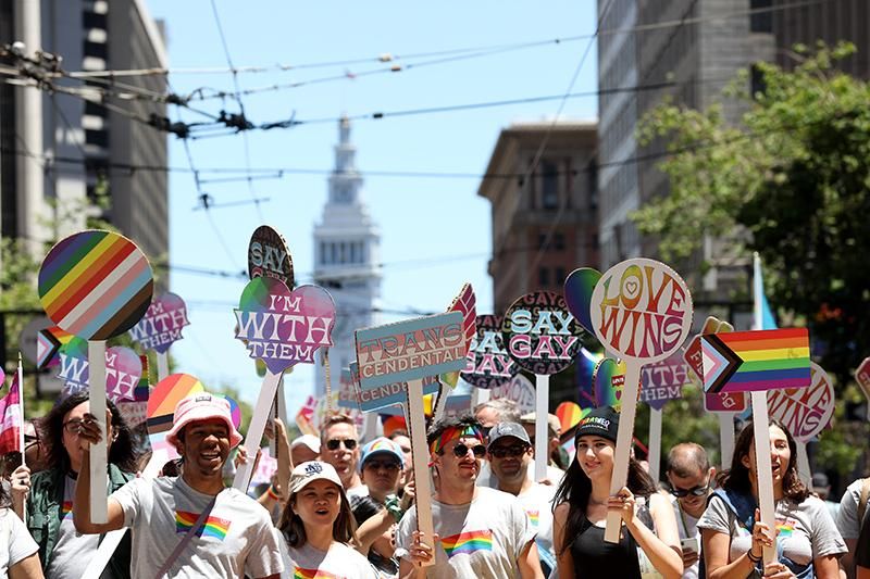 Marchers carry signs during the 52nd Annual San Francisco Pride Parade and Celebration on June 26, 2022