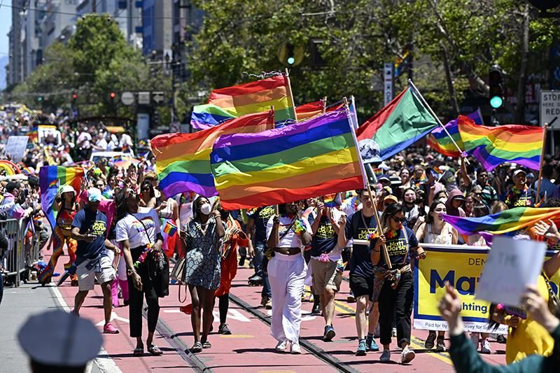 People march with giant Pride flags during the 52nd annual San Francisco Pride Parade on June 26, 2022