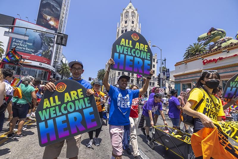 People march through the landmark intersection of Hollywood and Highland during the annual Pride Parade on June 12, 2022 in the Hollywood section of Los Angeles, California. The event returns after a two-year hiatus due to the COVID-19 pandemic.