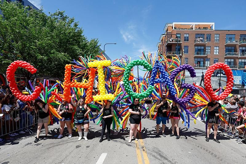 Participants carry balloons spelling out "Chicago" during the 51st LGBTQ Pride Parade in Chicago, Illinois, on June 26, 2022. The Pride Parade returned to the Lakeview and Uptown neighborhoods after a three year hiatus due to the coronavirus pandemic.