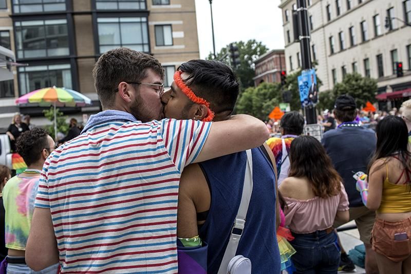 Two men are seen kissing during the annual Pride Parade celebrations in Washington DC. Thousands gathered for the parade, which was back fully in-person after two years of modified celebrations because of the pandemic.