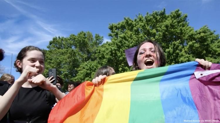 Image of teens with rainbow flag